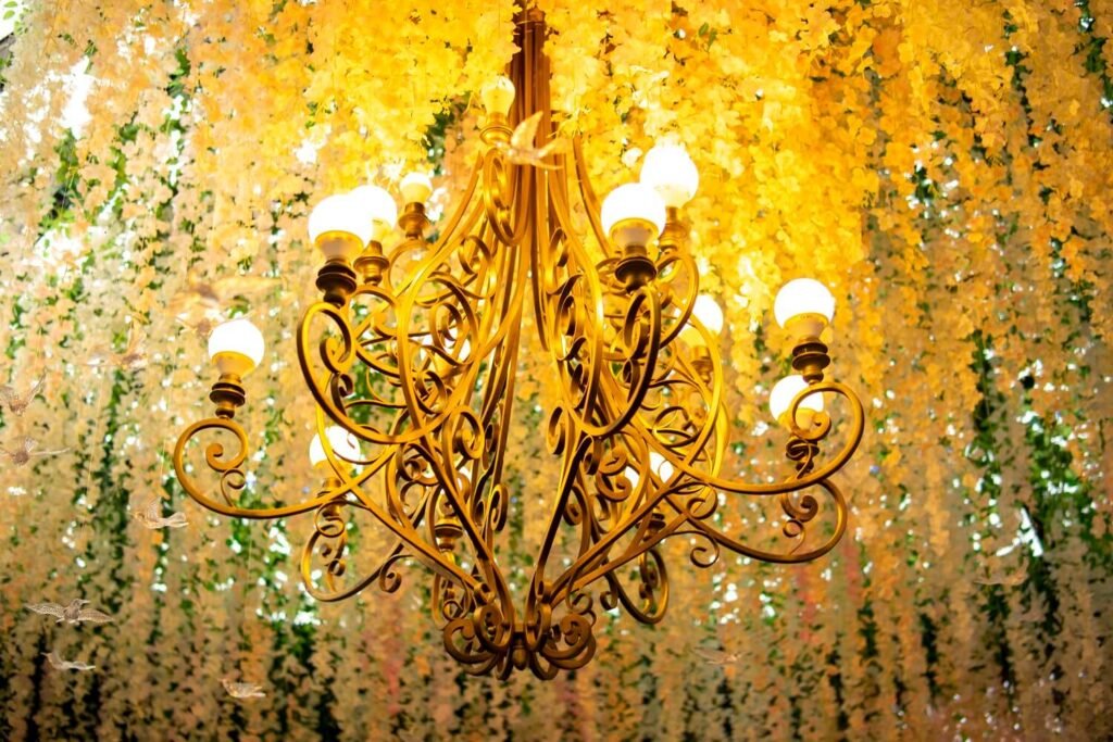 Luxury gold chandelier and floral ceiling decor at The Maison, a premier choice for planning events in Bradford.