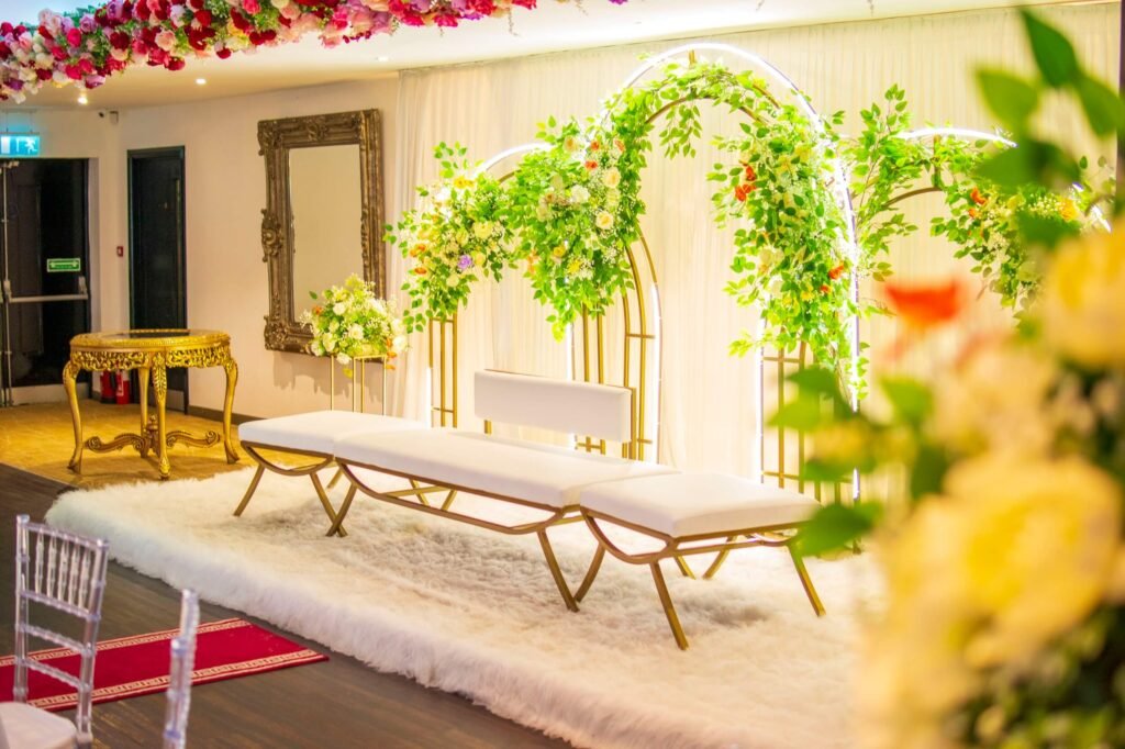 Modern bridal stage with floral arches, white seating, and plush faux fur rug at The Maison Bradford