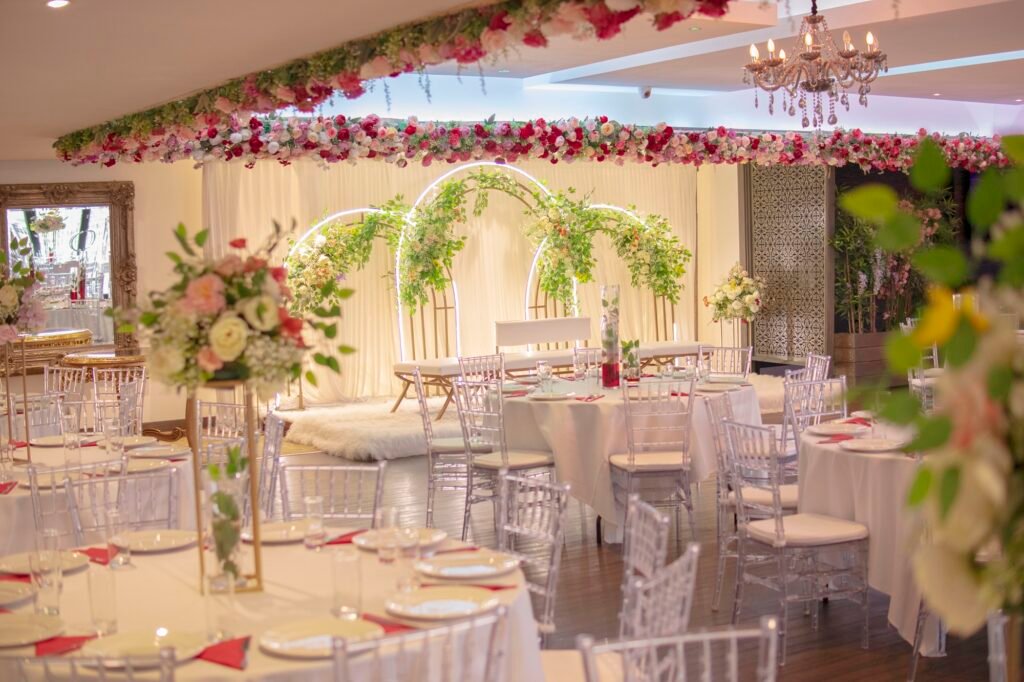 Floral wedding stage at The Maison, a luxury Asian wedding venue Bradford with elegant seating.