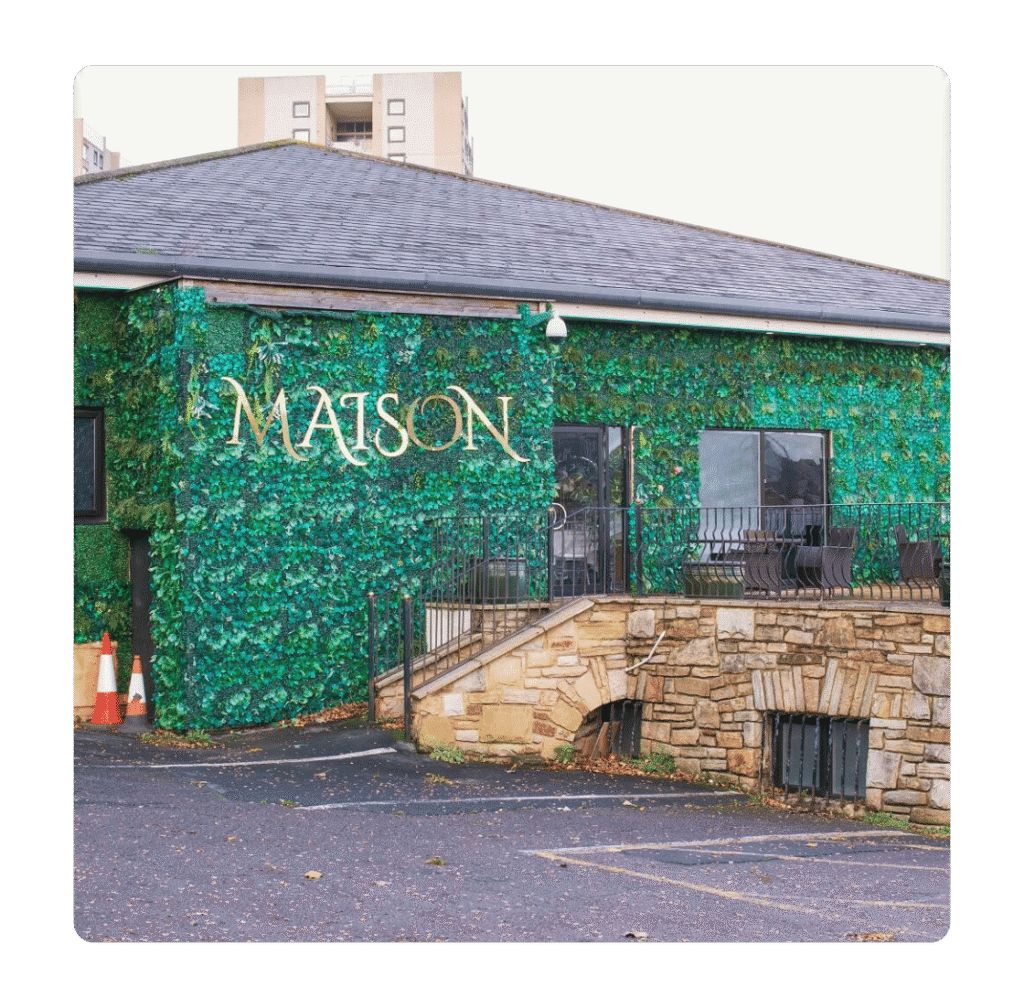 Wedding venue exterior at The Maison Bradford with ivy wall and stone features on Manchester Road in Bradford.