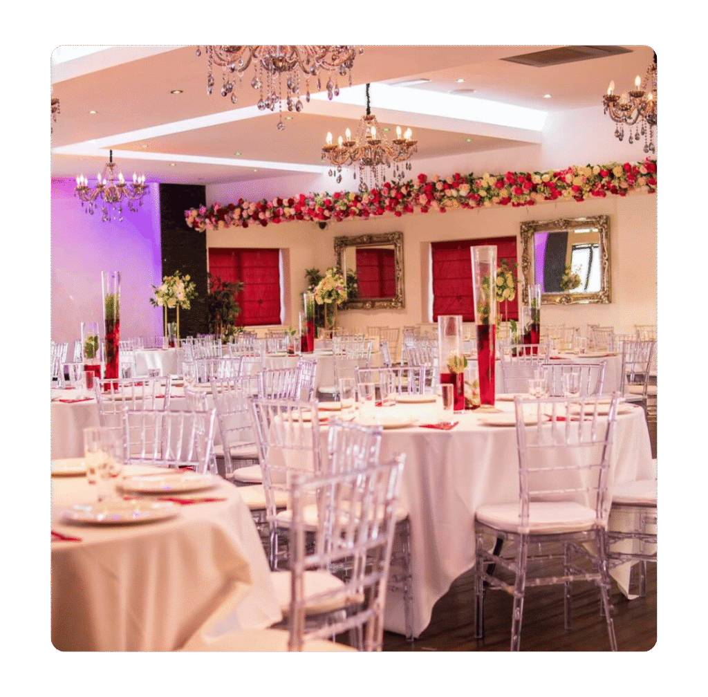 Main hall event layout at The Maison Bradford with clear chairs, floral décor and chandelier lighting for weddings, parties and business events.