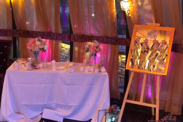 Dholki decor at The Maison Bradford in Bradford with floral displays, candles, and warm lighting for Asian pre-wedding events in West Yorkshire.